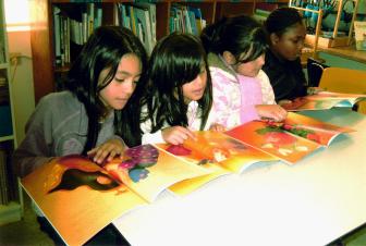 Schoolchildren from East Palo Alto enjoying their holiday gift of Neem the Half-Boy thanks to a grant from Kaiser Permanente Community Benefits program and other supporters. Share Literacy was able to provide these books to the EPAK Foundation to give out to children.