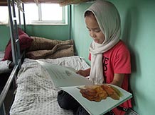 Afghan Girl Reading The Lion Who Saw Himself in the Water